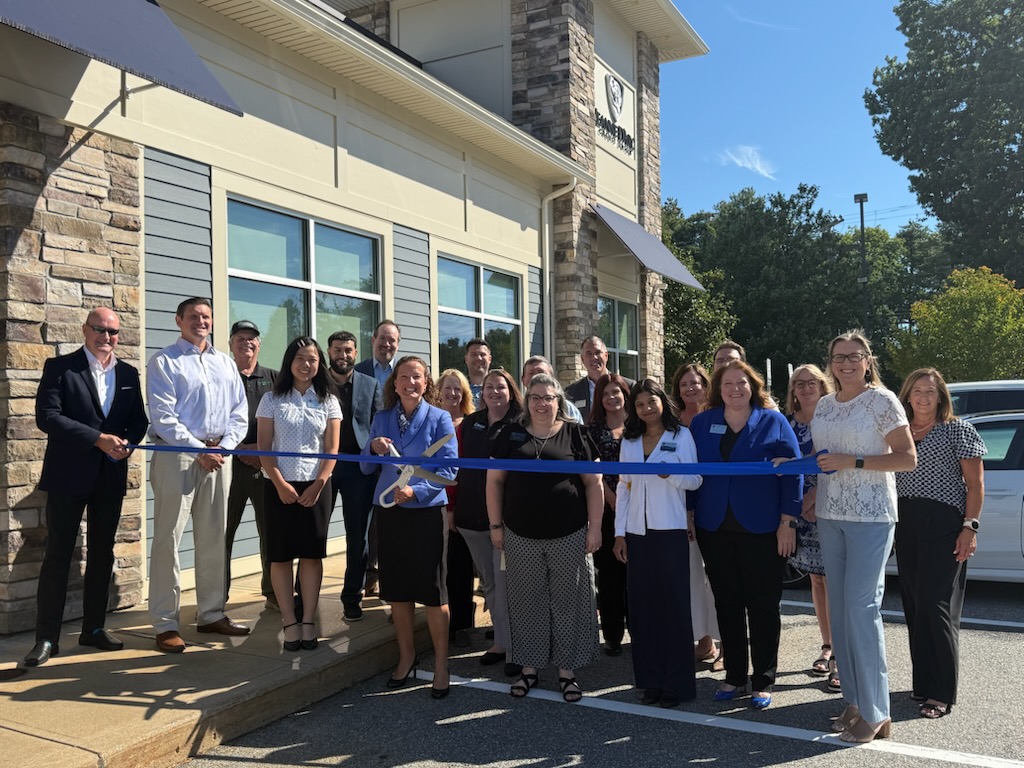 Jeanne D’Arc Credit Union staff and community members at a ribbon-cutting outside the Nashua branch